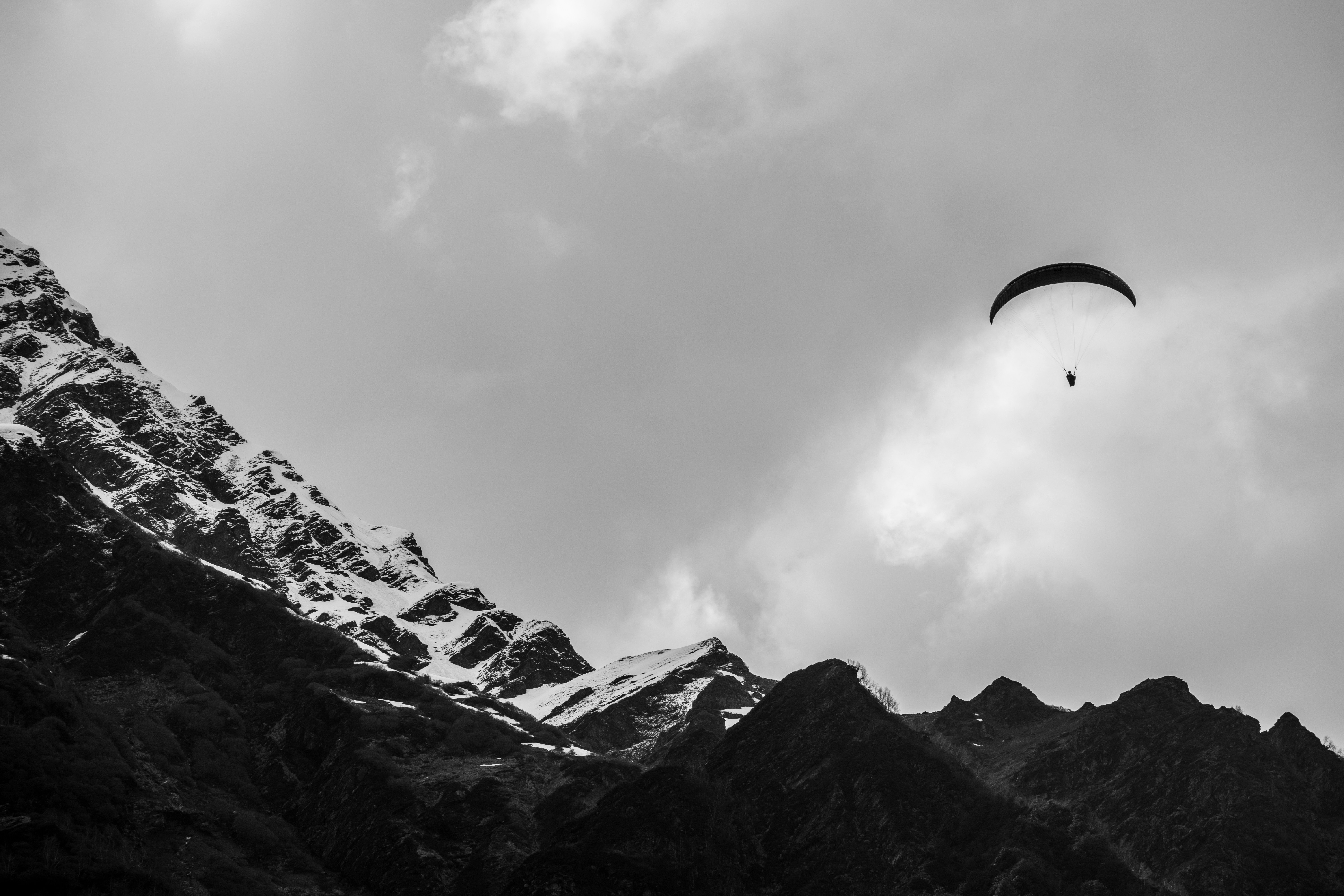 Un parapente está volando sobre una cadena montañosa