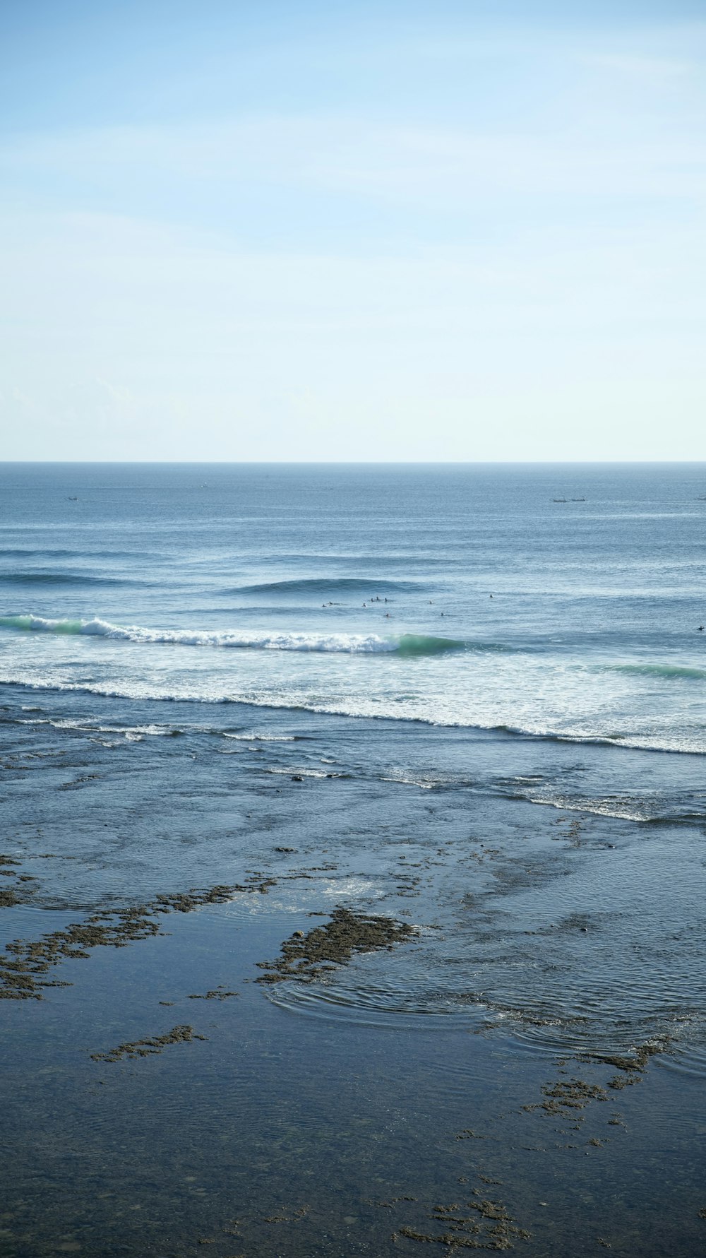 a person riding a surfboard on top of a wave