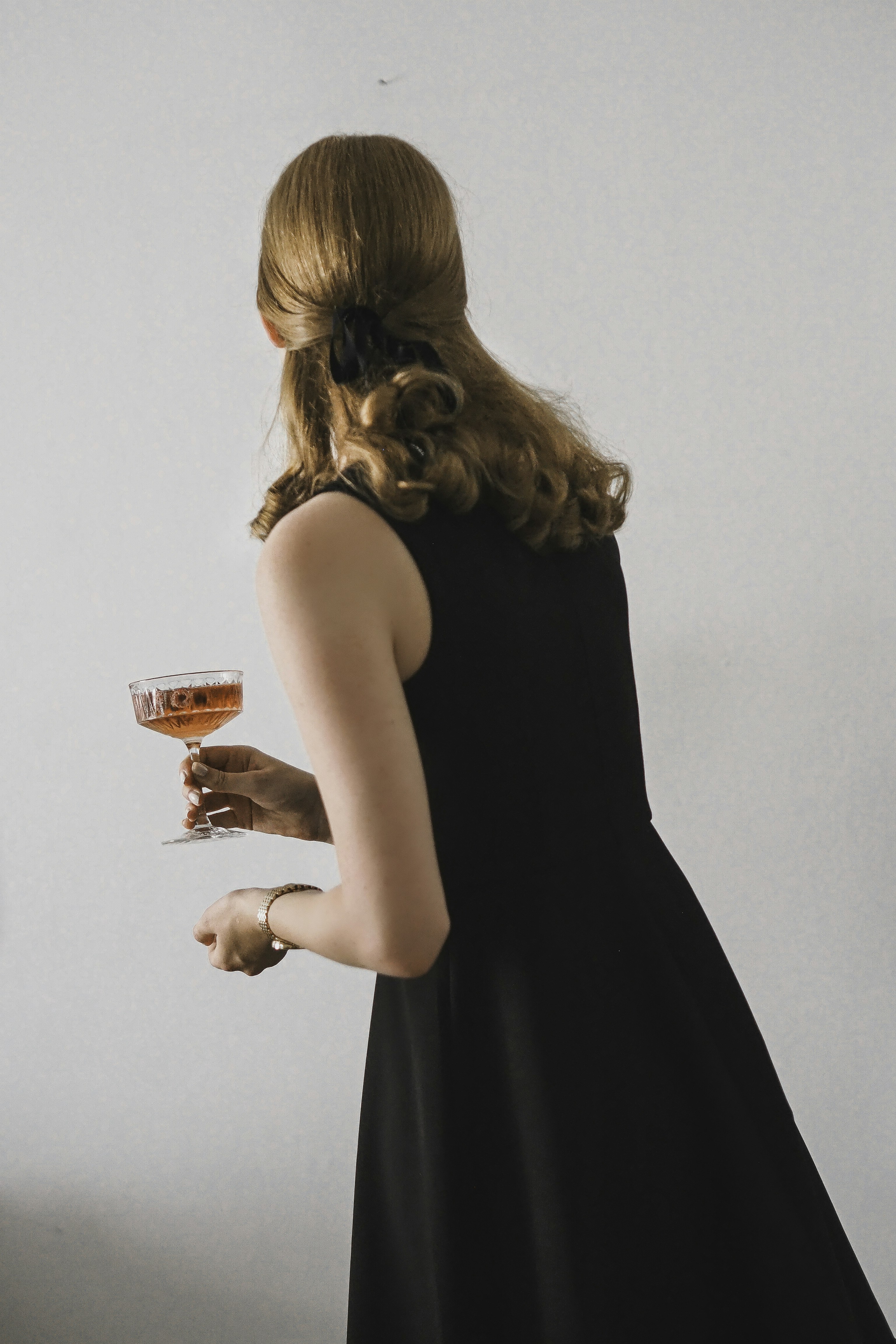 A woman in a black dress holding a glass of wine photo  Free Paris Image  on Unsplash