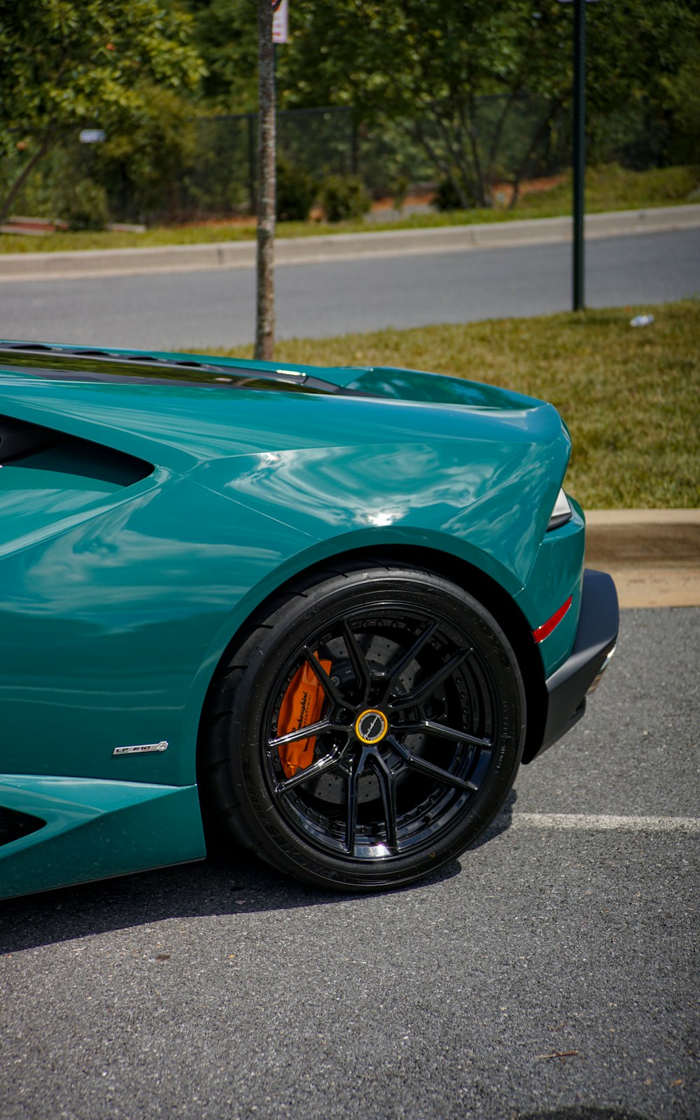 a blue sports car parked in a parking lot