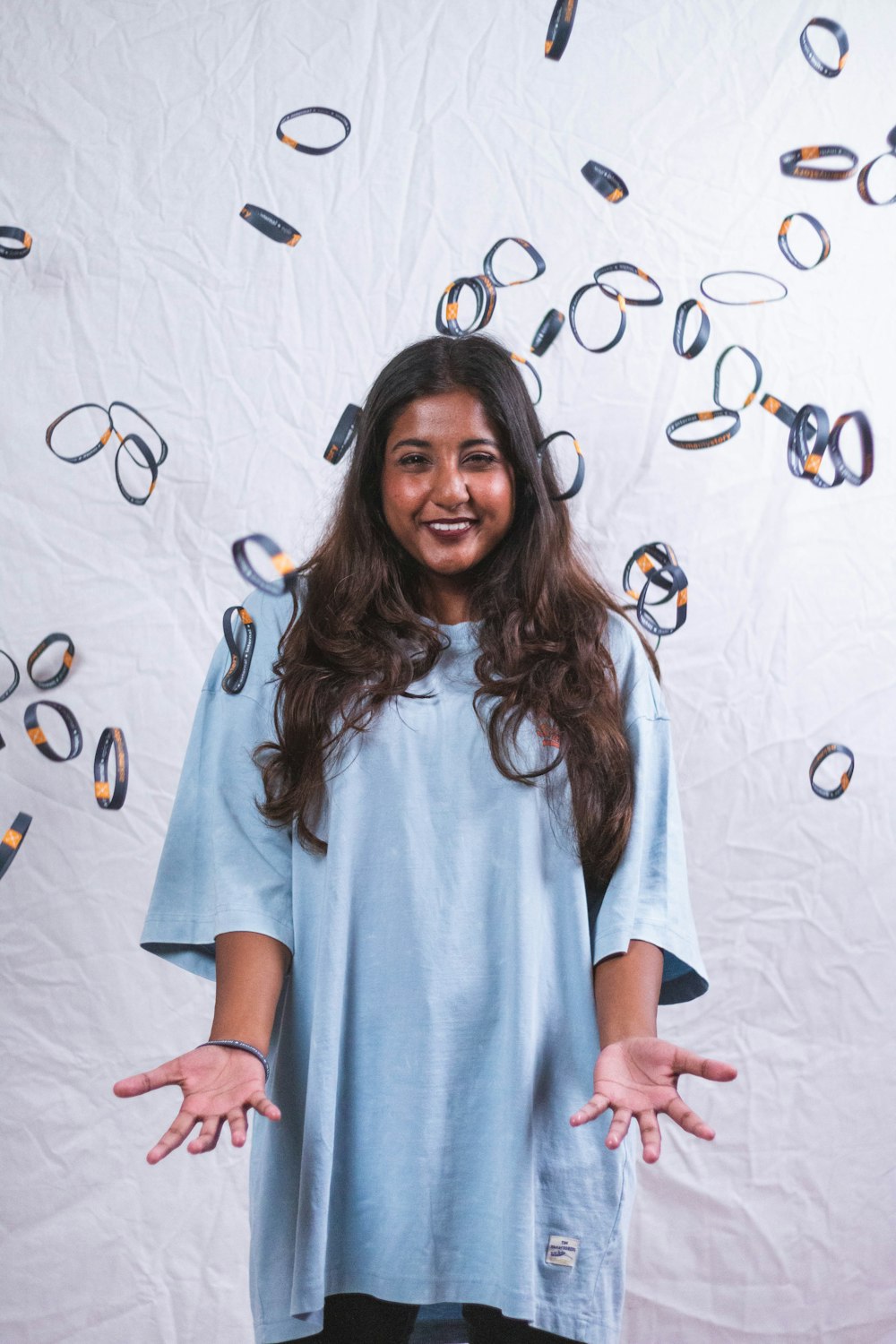 a woman standing in front of a wall with glasses on it