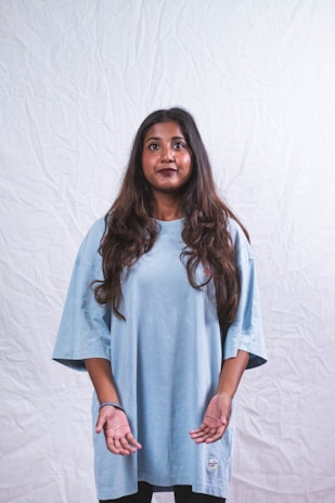Model wearing a relaxed-fit oversized tee in a calm, neutral shade against a simple backdrop.