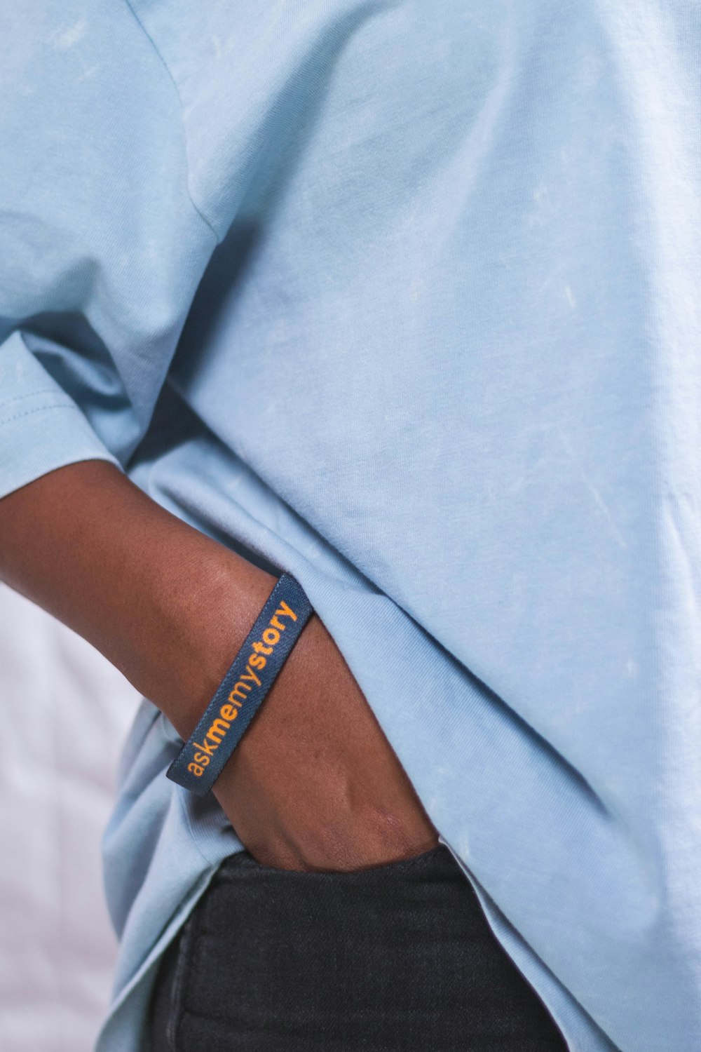 a person wearing a blue shirt and a blue wristband