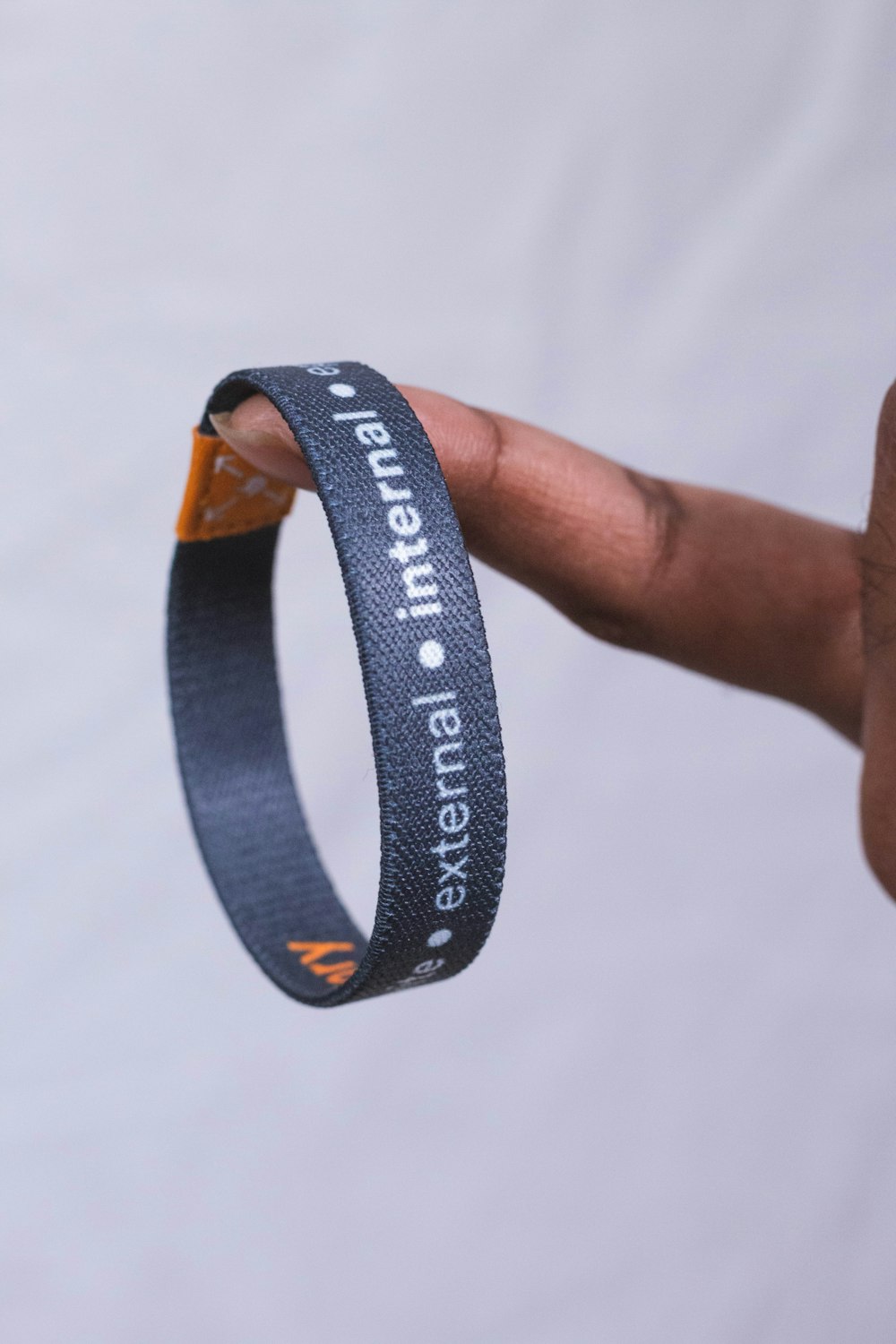 a hand holding a wristband with a message on it