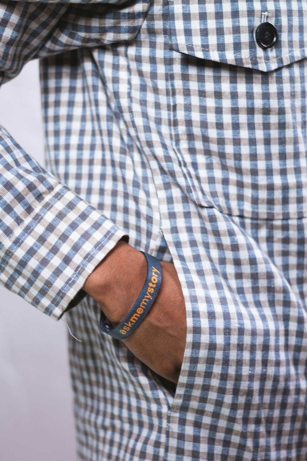 a man wearing a blue and white checkered shirt