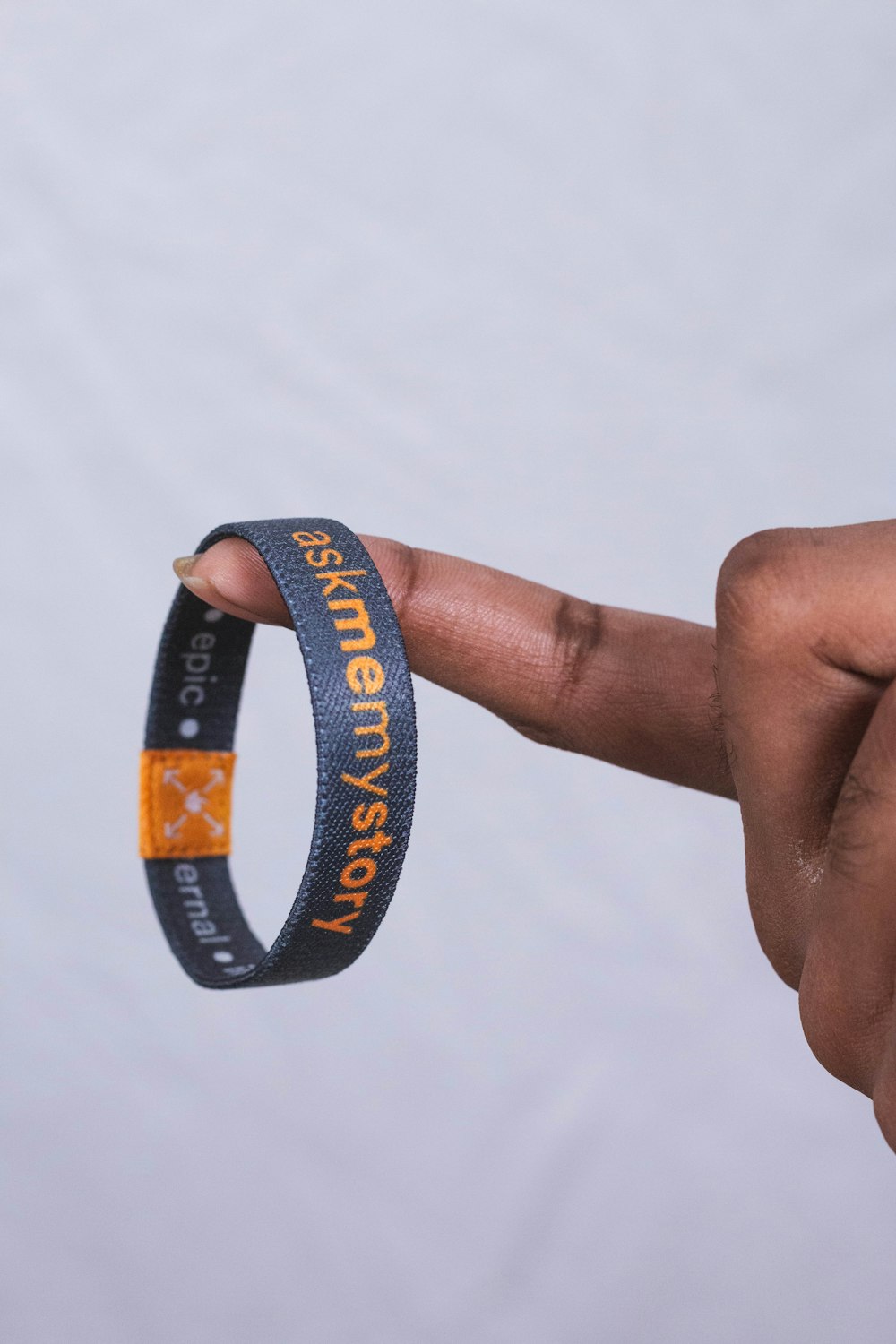 a hand holding a wristband with a message on it