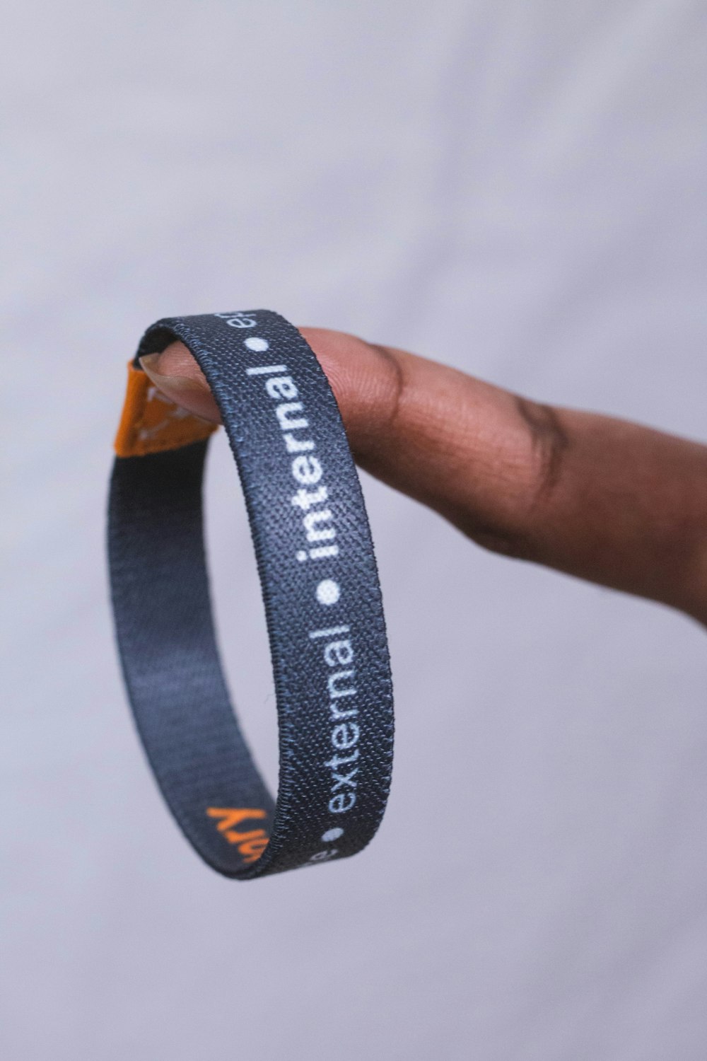 a person holding a wristband with a message on it
