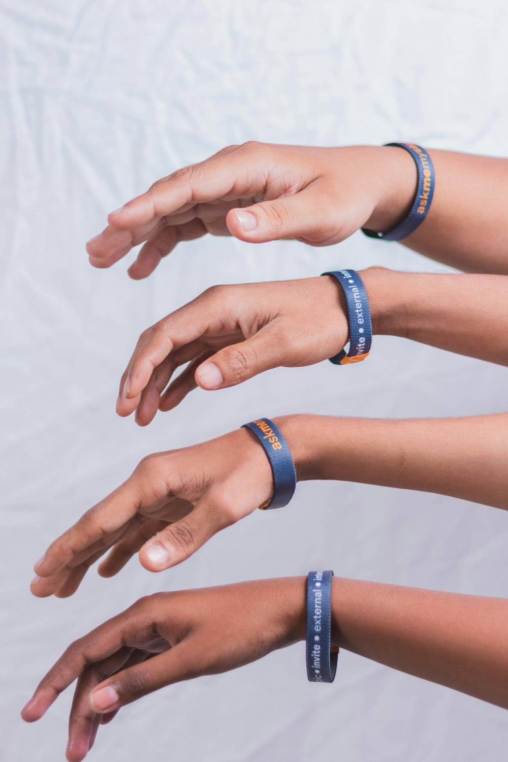 a group of people with wrist bands on their hands