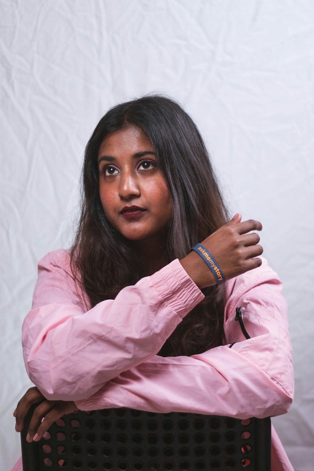 a woman in a pink shirt is posing for a picture