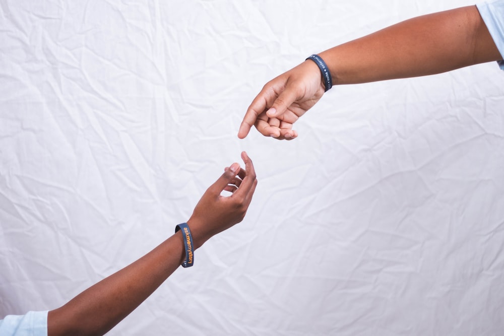 two people reaching out their hands to each other