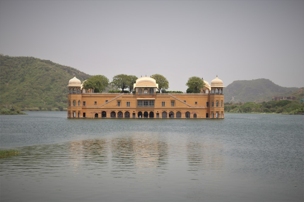 a large building sitting on top of a lake