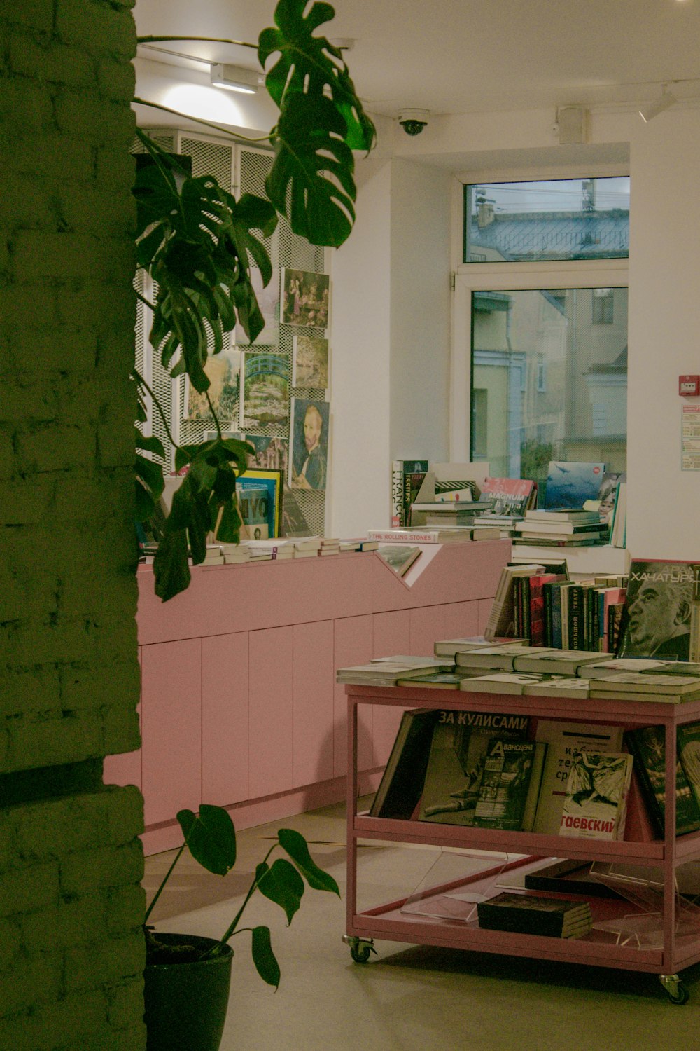 a pink table in a room with books on it