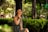 A happy woman wearing a stylish dress in a park.