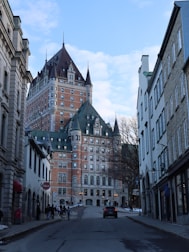 a city street lined with tall buildings and tall towers