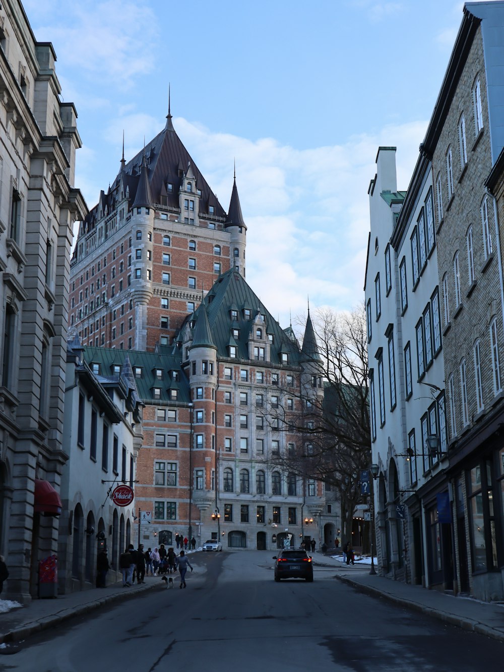 a city street lined with tall buildings and tall towers