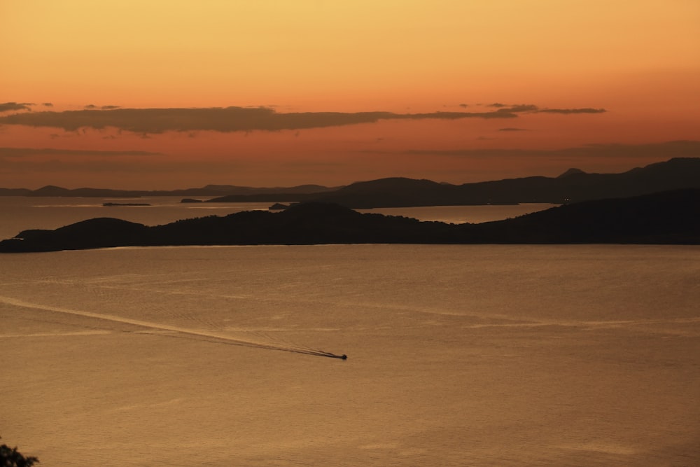 a boat traveling across a large body of water