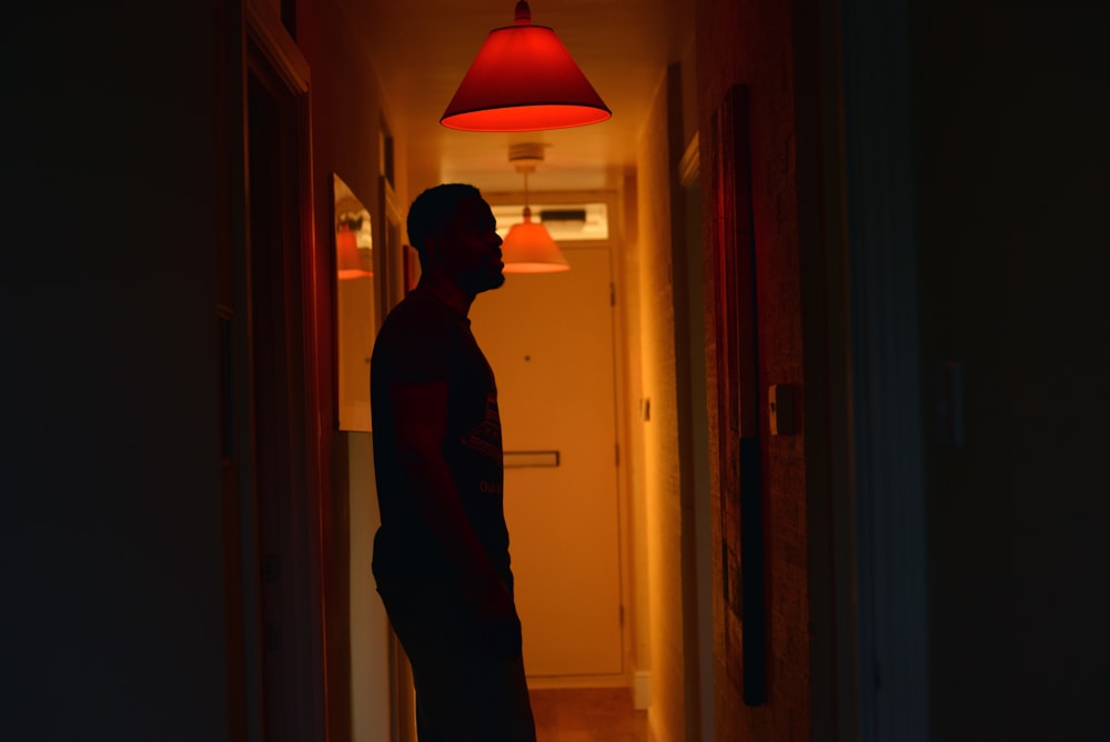 a man standing in a hallway at night