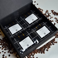 A colorful array of coffee bombs nestled in rustic wooden crates, ready for gifting.