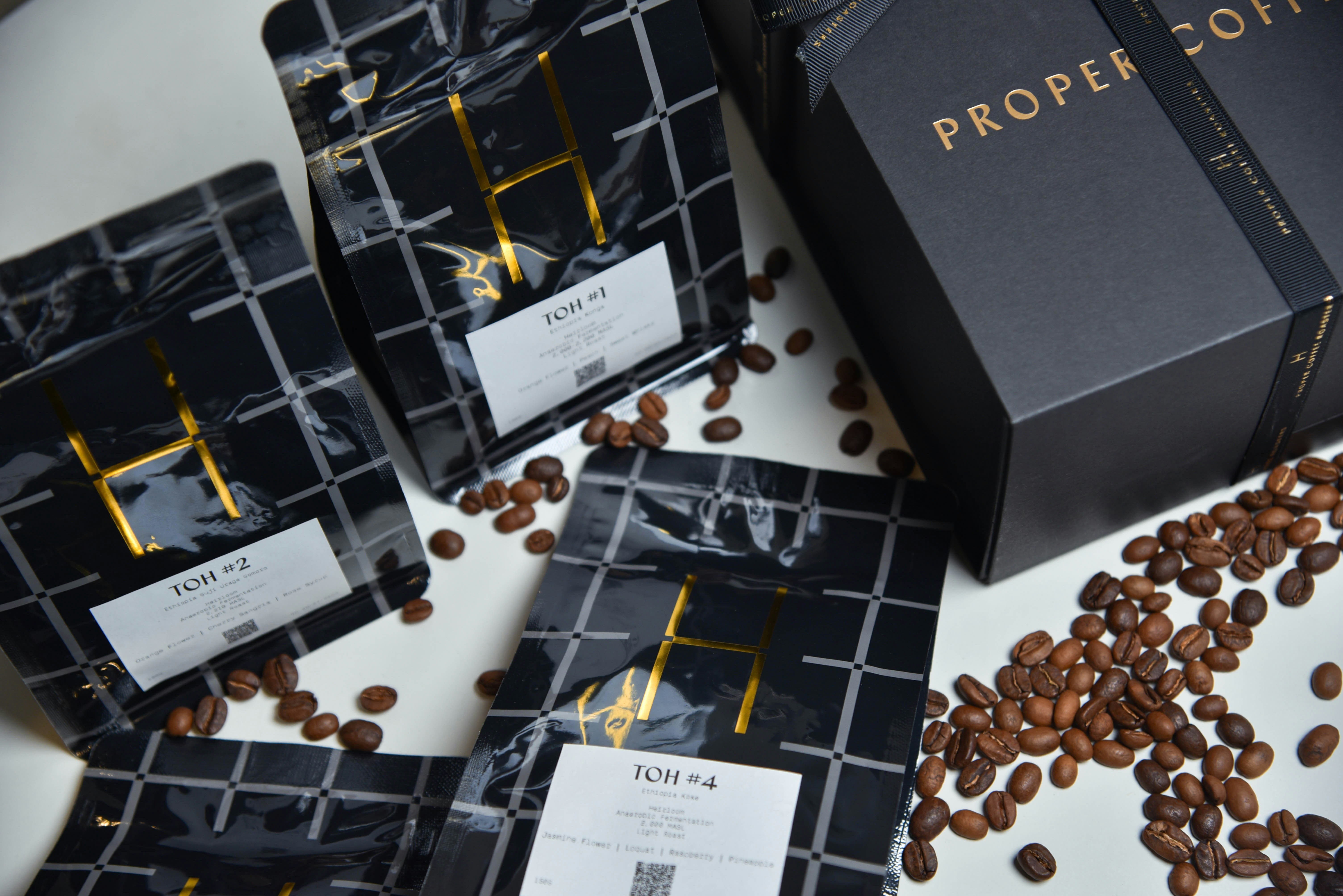 Wooden gift box containing premium coffee beans and assorted tea sachets with festive ribbon