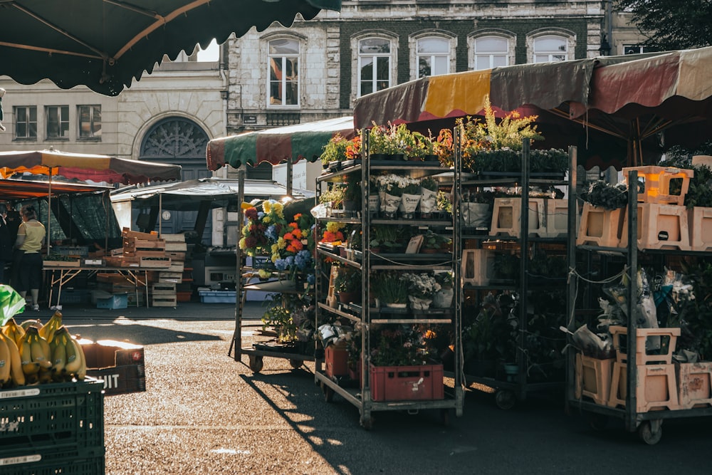 an outdoor market with bananas and other produce