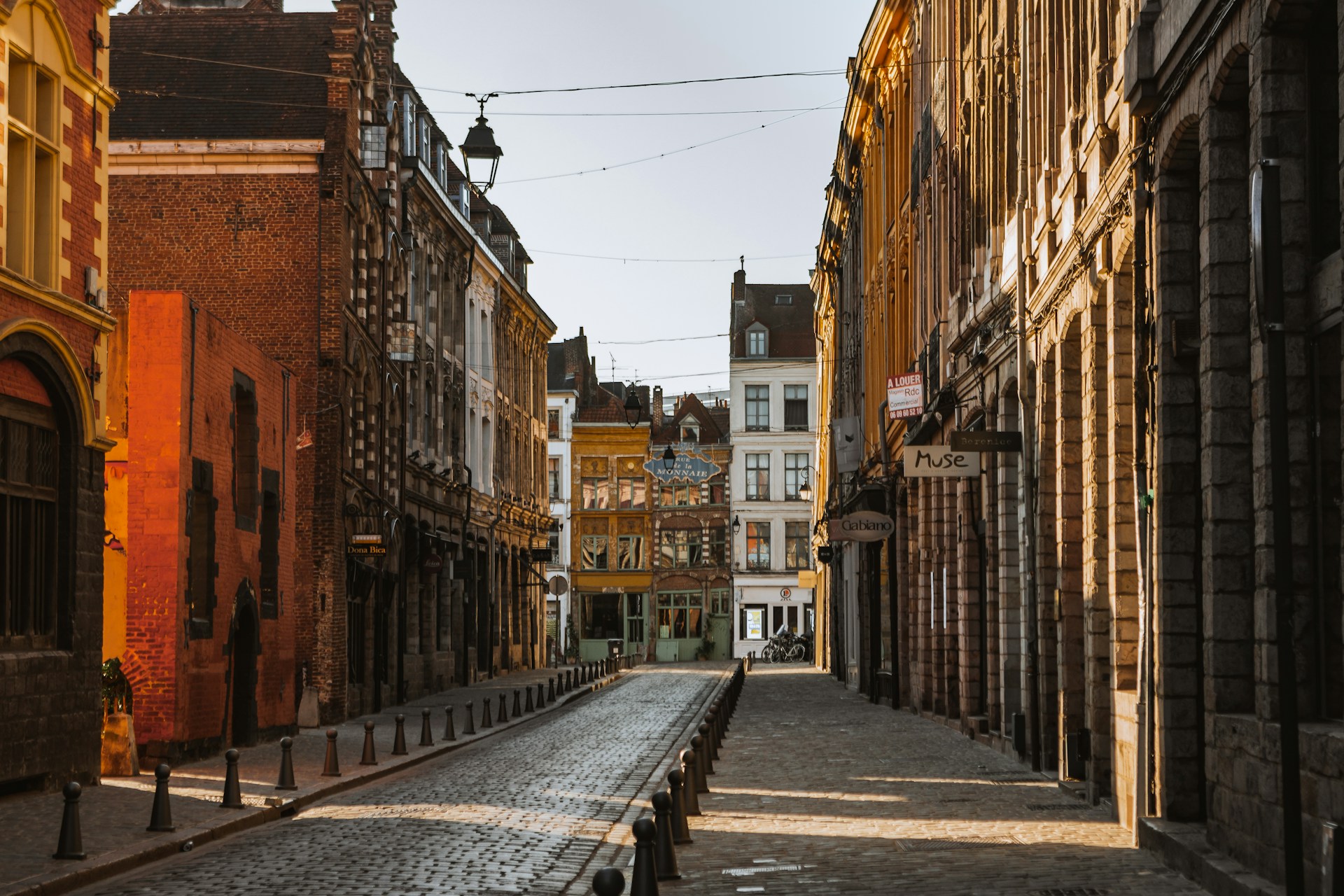 a cobblestone street lined with old buildings