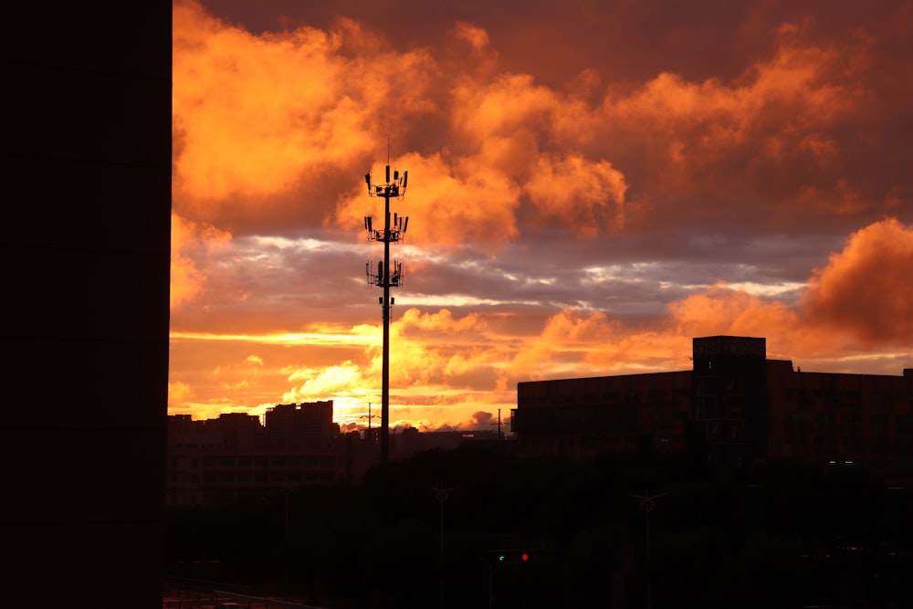 the sun is setting over a city with tall buildings