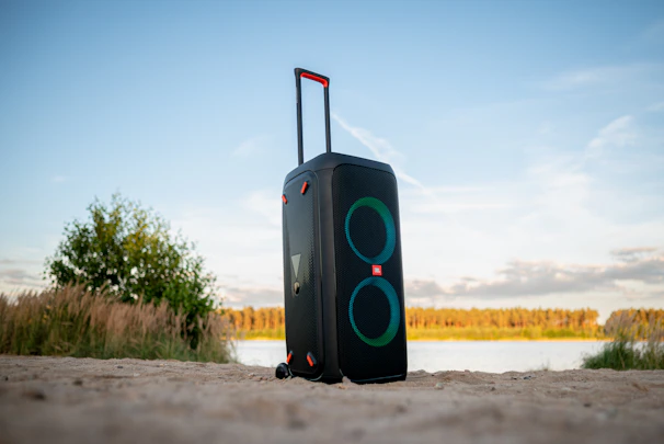 A vibrant outdoor scene showing portable speakers in use during a casual gathering.