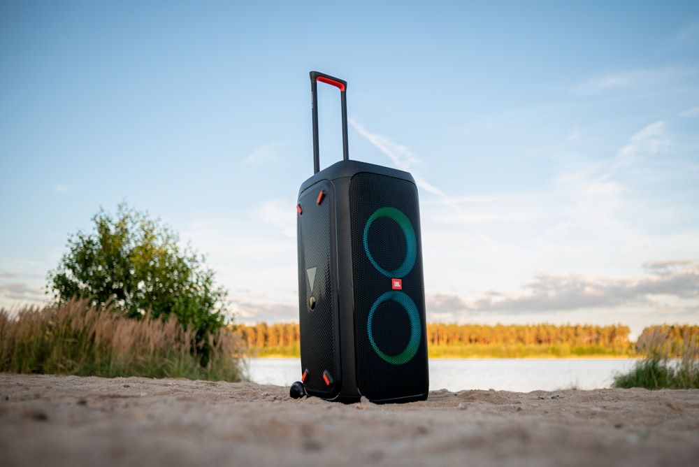 a piece of luggage sitting on top of a sandy beach