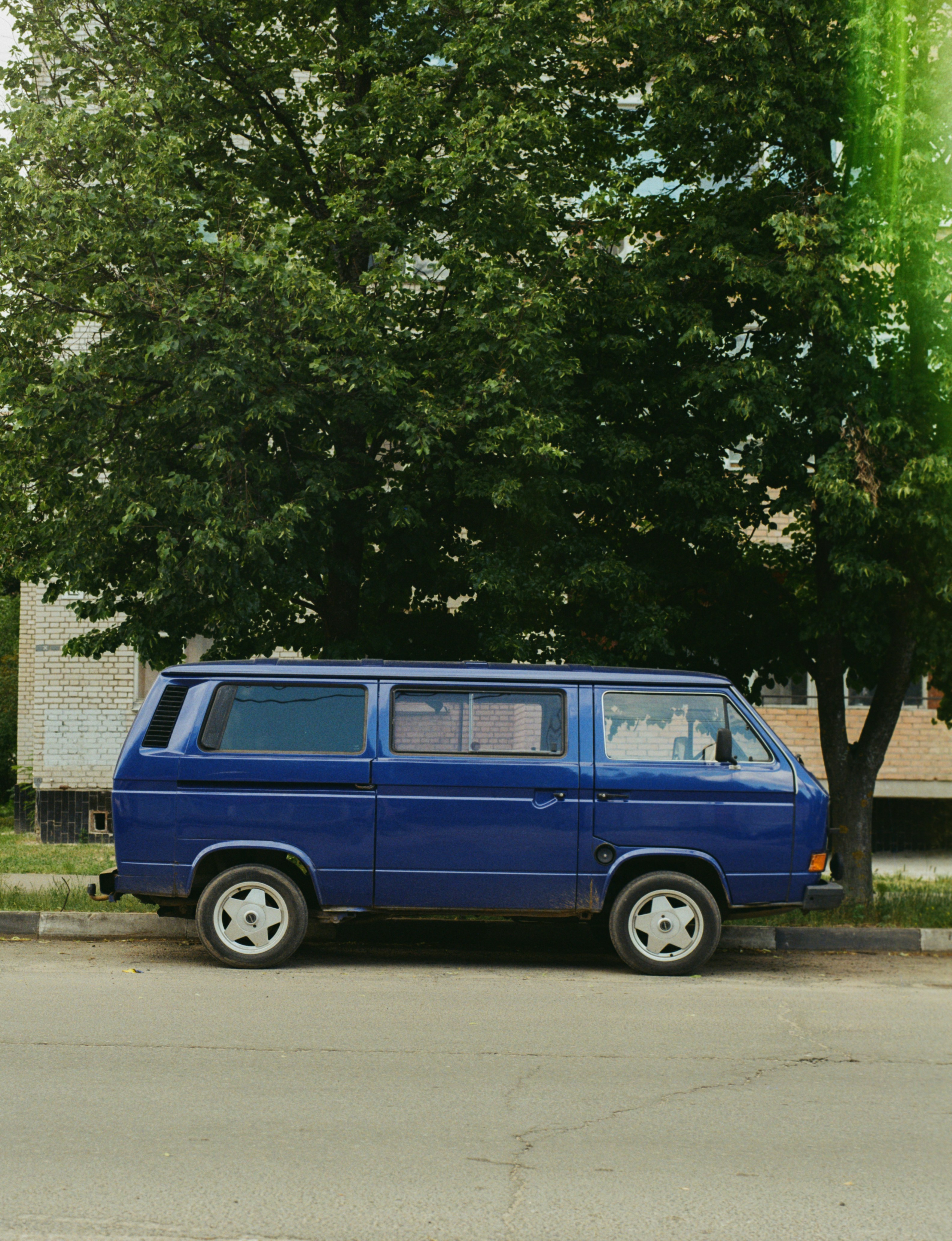 A blue van parked on the side of the road photo – Free Dubna Image on ...