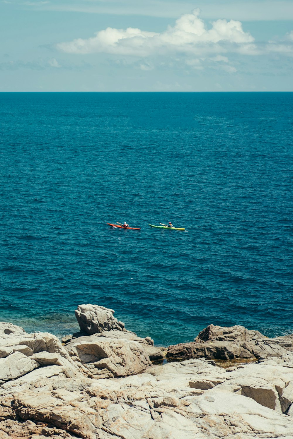 a couple of kayaks floating on top of a large body of water