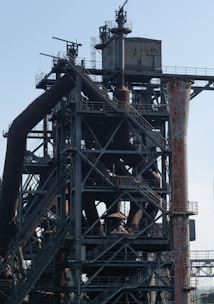 a very tall metal structure with lots of pipes