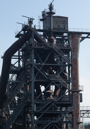 a very tall metal structure with lots of pipes