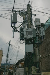 a bunch of wires and wires hanging from a pole