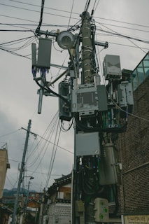 a bunch of wires and wires hanging from a pole