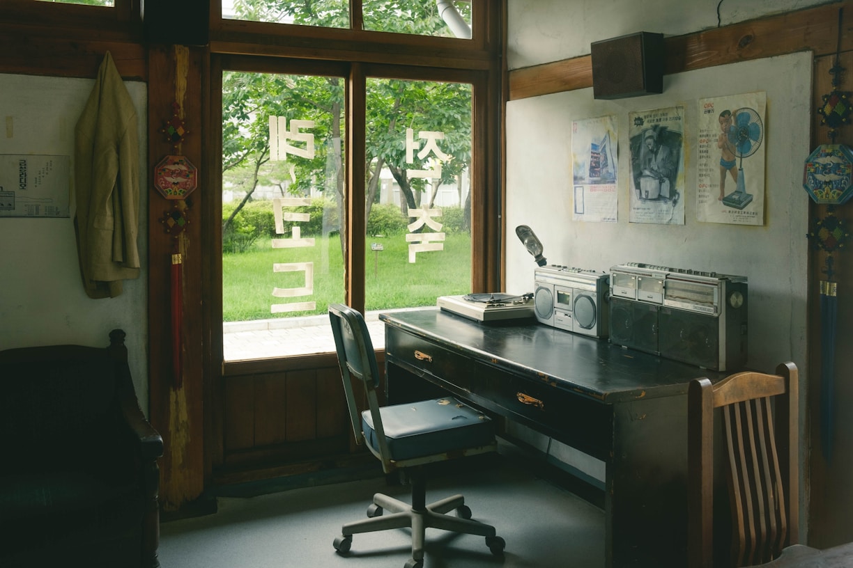 a room with a desk, chair and a window