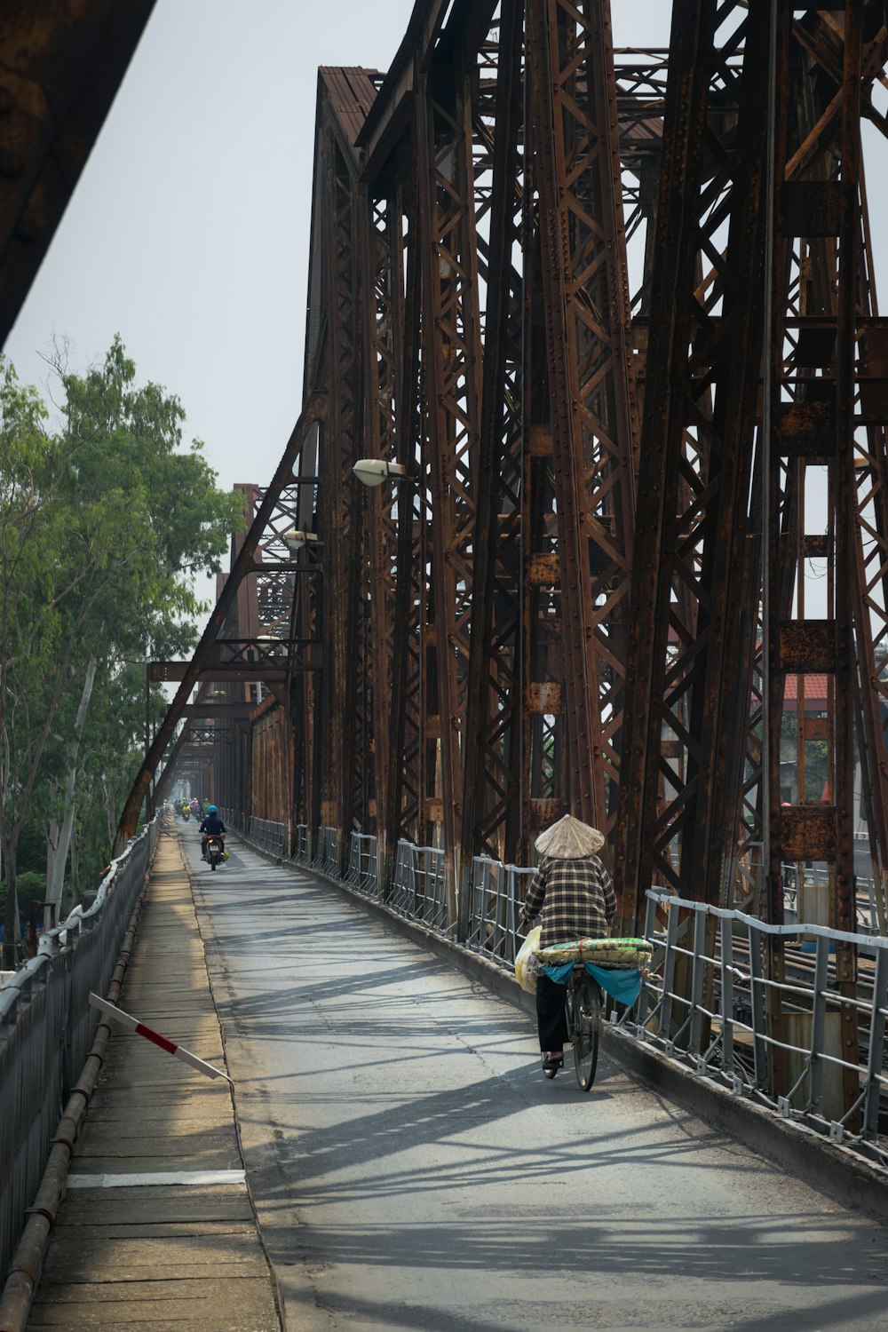 a person with an umbrella walking across a bridge