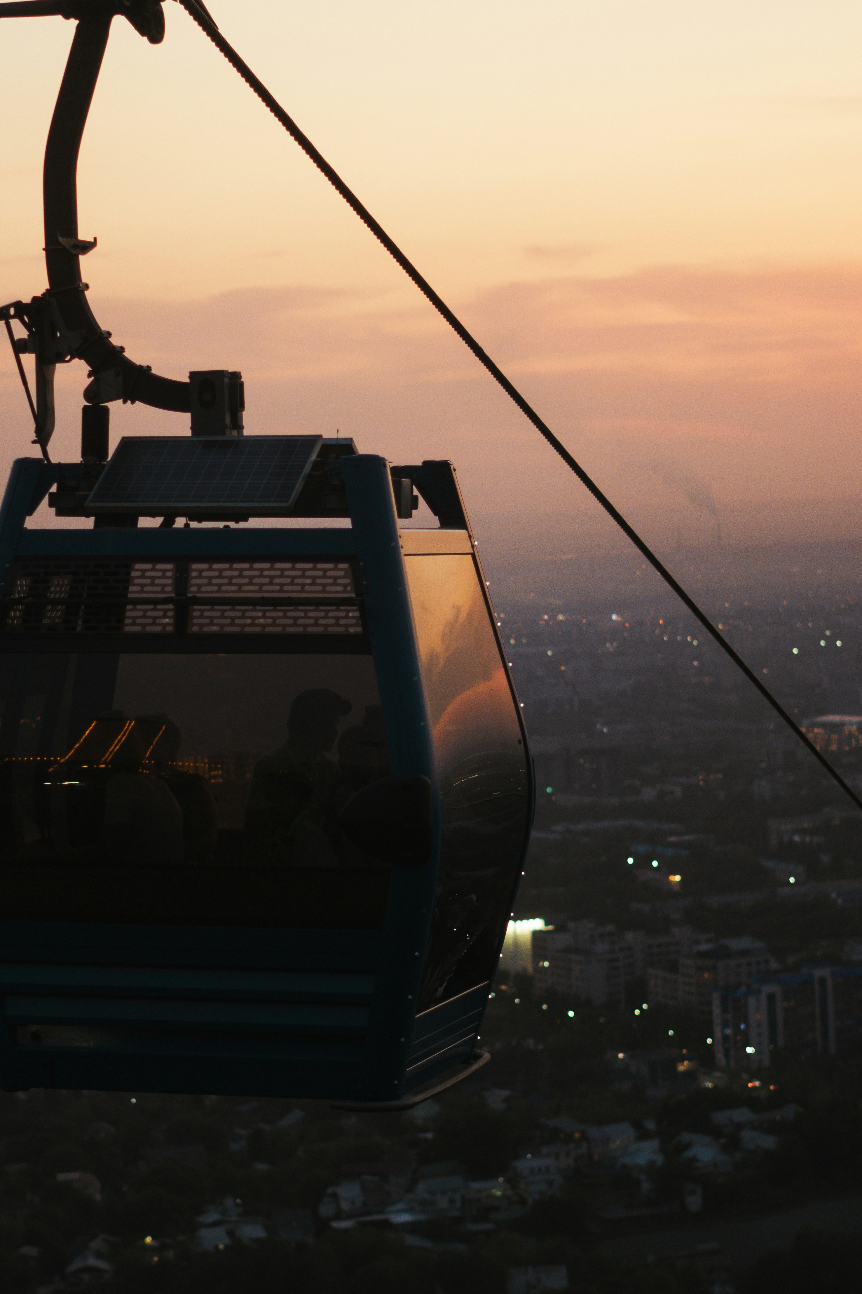 A gondola with a view of a city at sunset photo – Free Kok tobe Image ...