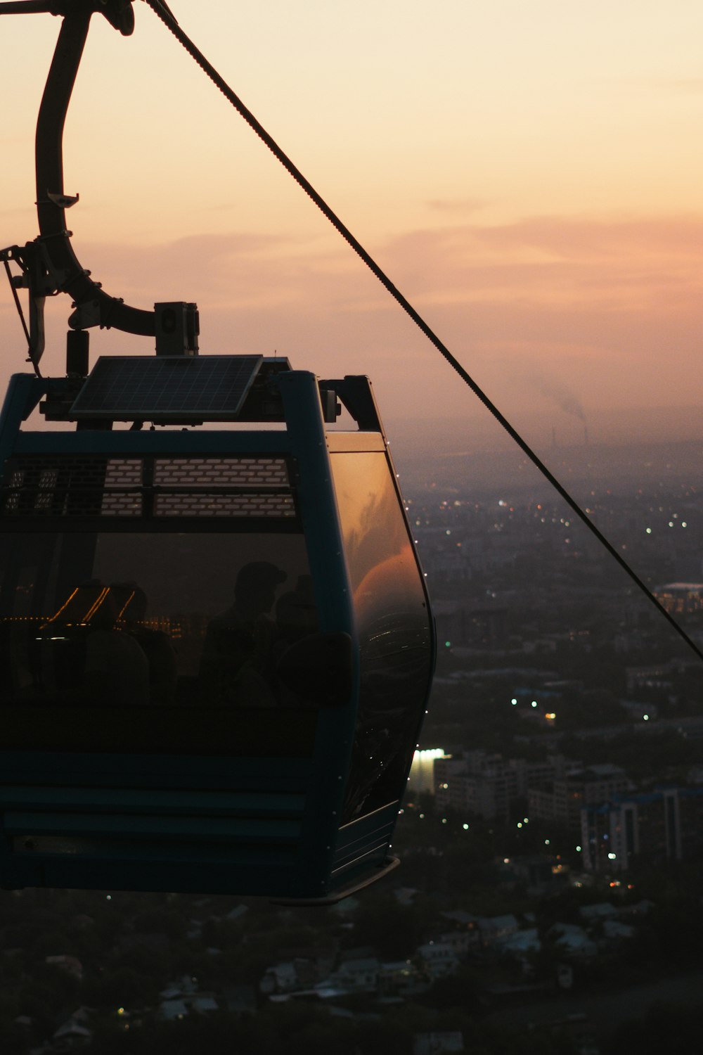 a gondola with a view of a city at sunset