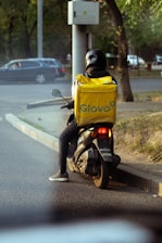 a man riding a motorcycle down a street