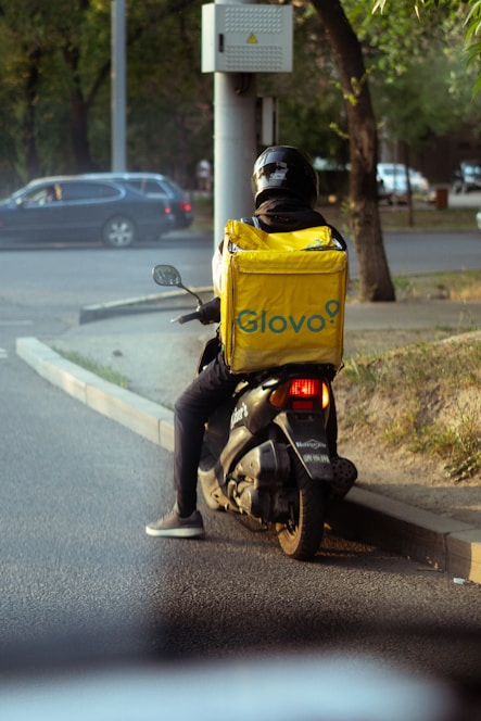 a man riding a motorcycle down a street