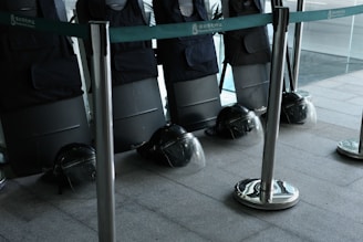Array of protective gloves and helmets laid out on a workbench.