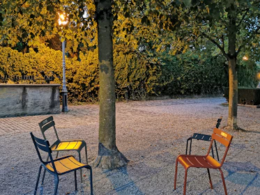 The 1000 empty chairs arranged solemnly at Place du Trocadéro under a soft evening light, inviting reflection.