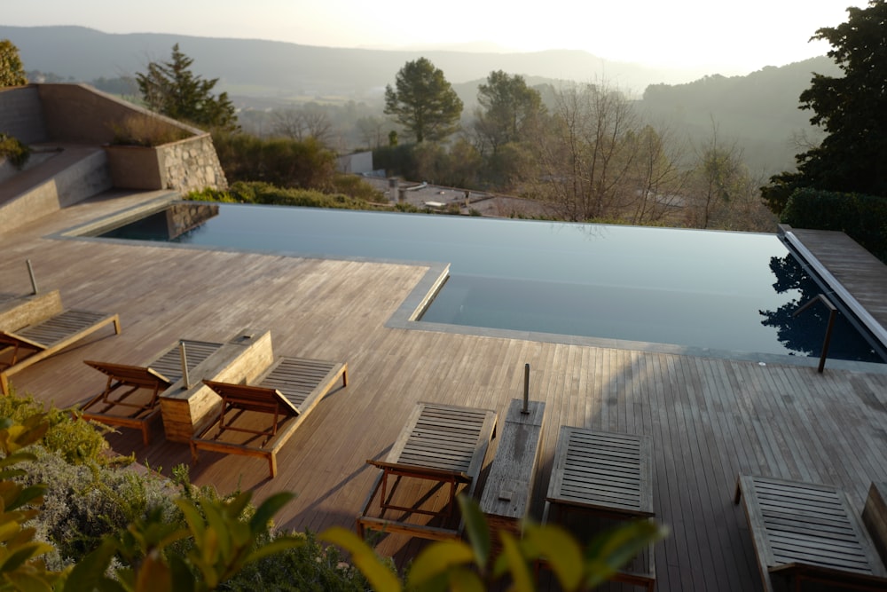 a wooden deck next to a swimming pool