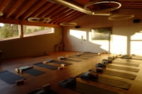 a large room with a lot of yoga mats on the floor