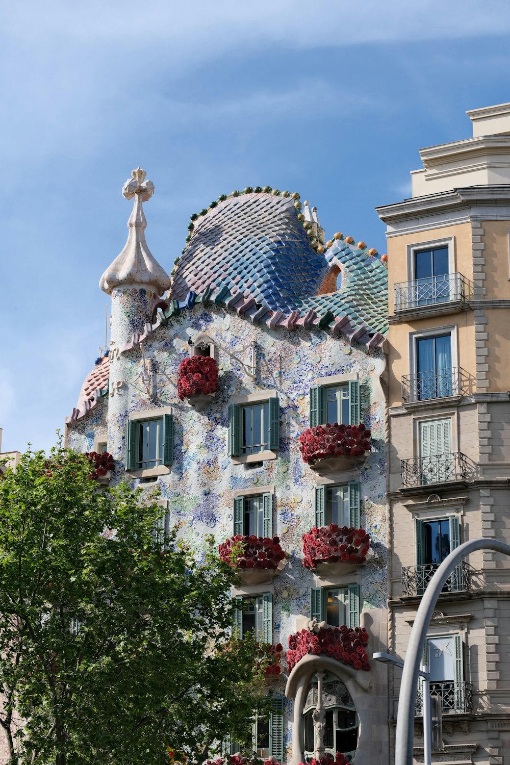 a tall building with many windows and flowers on it