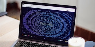 a laptop computer sitting on top of a wooden desk