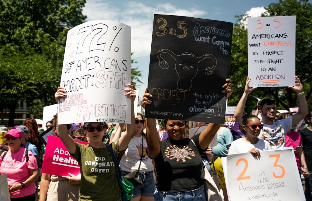 a group of people holding up signs in the air