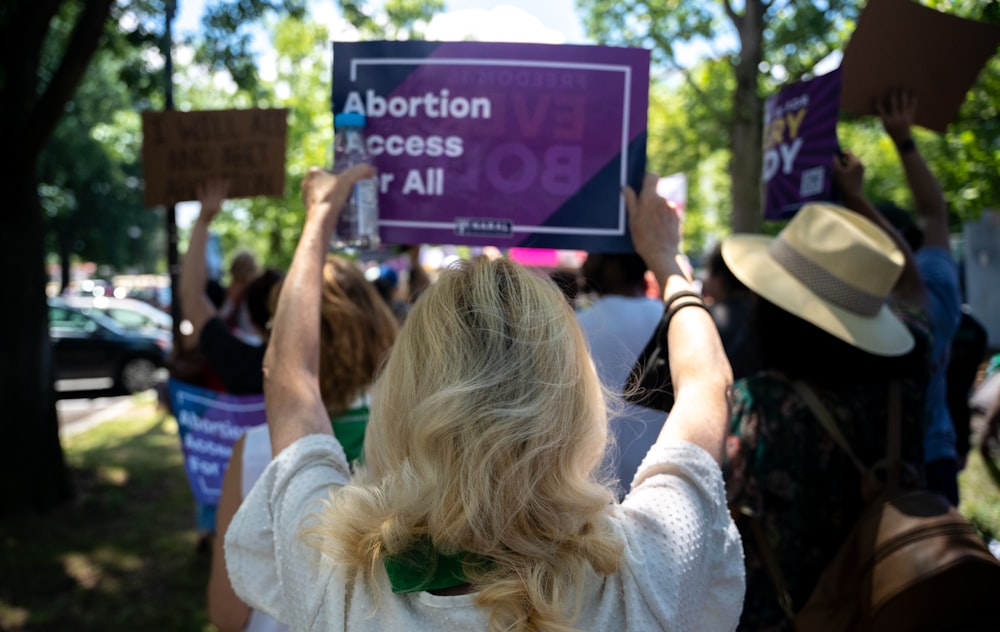 a group of people holding up signs in the air