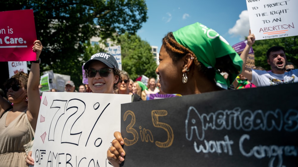 a group of people holding signs in a protest