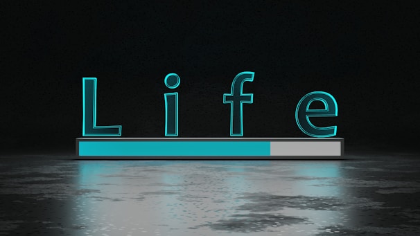 The word 'Life' is displayed in large, glowing teal letters above a horizontal progress bar that is partially filled. The background is dark with a reflective surface below the text and bar, creating a sense of depth and modernity.